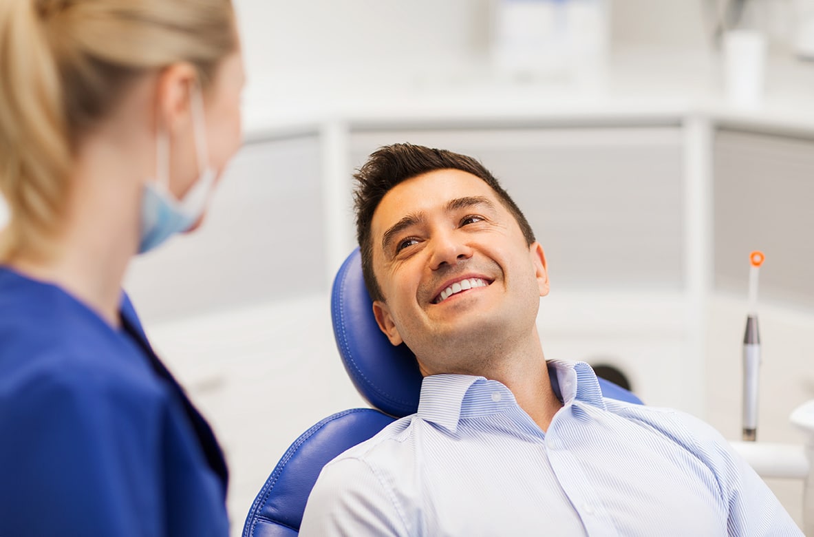 male dental patient speaking with dental hygienist during Scaling and Root Planing appointment at Highlands Periodontics and Implant Dentistry